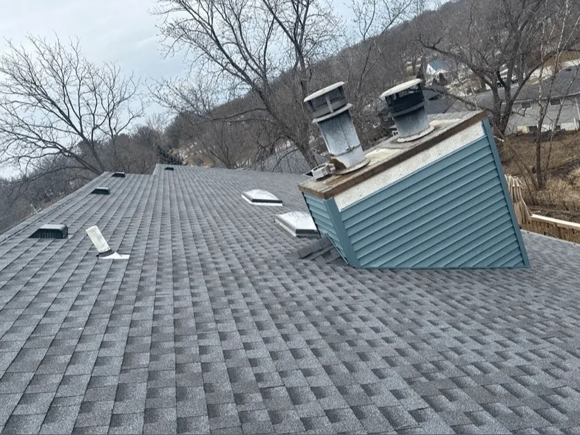A storm-damaged roof section repaired by New Summit Roofing