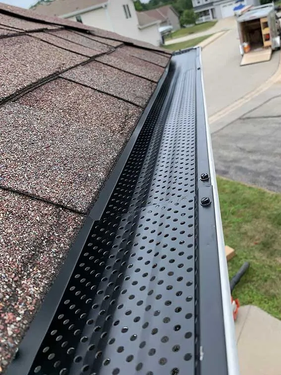 A seamless gutter with a leaf guard installed by New Summit Roofing