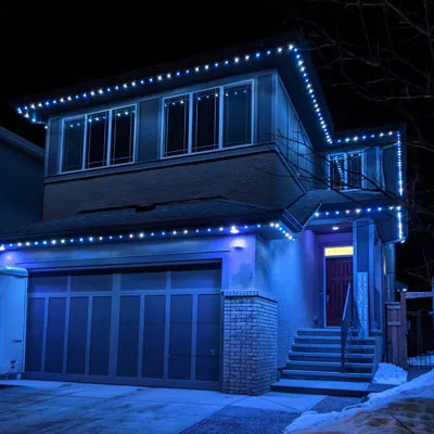 A two-story home with permanent LED lighting set to blue