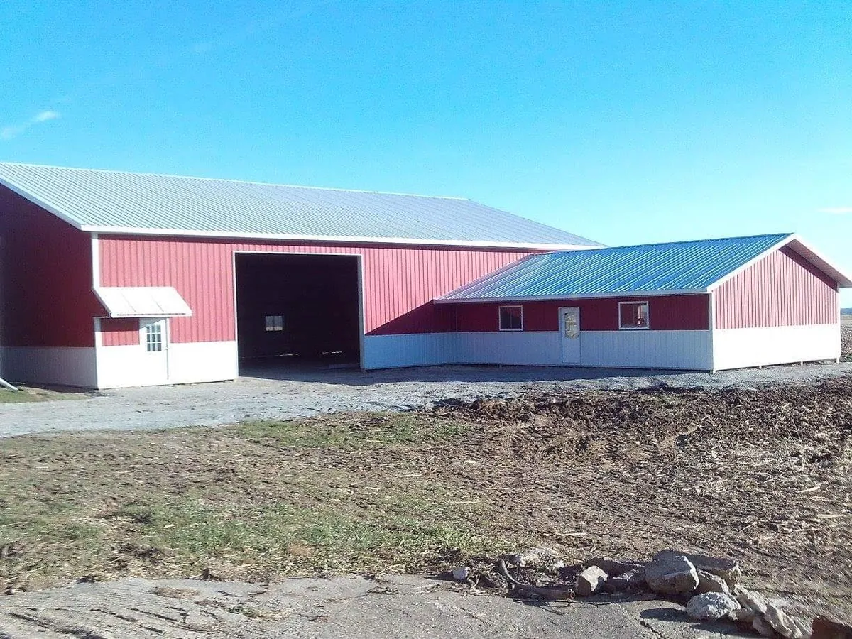 A large red pole barn with a metal roof and siding
