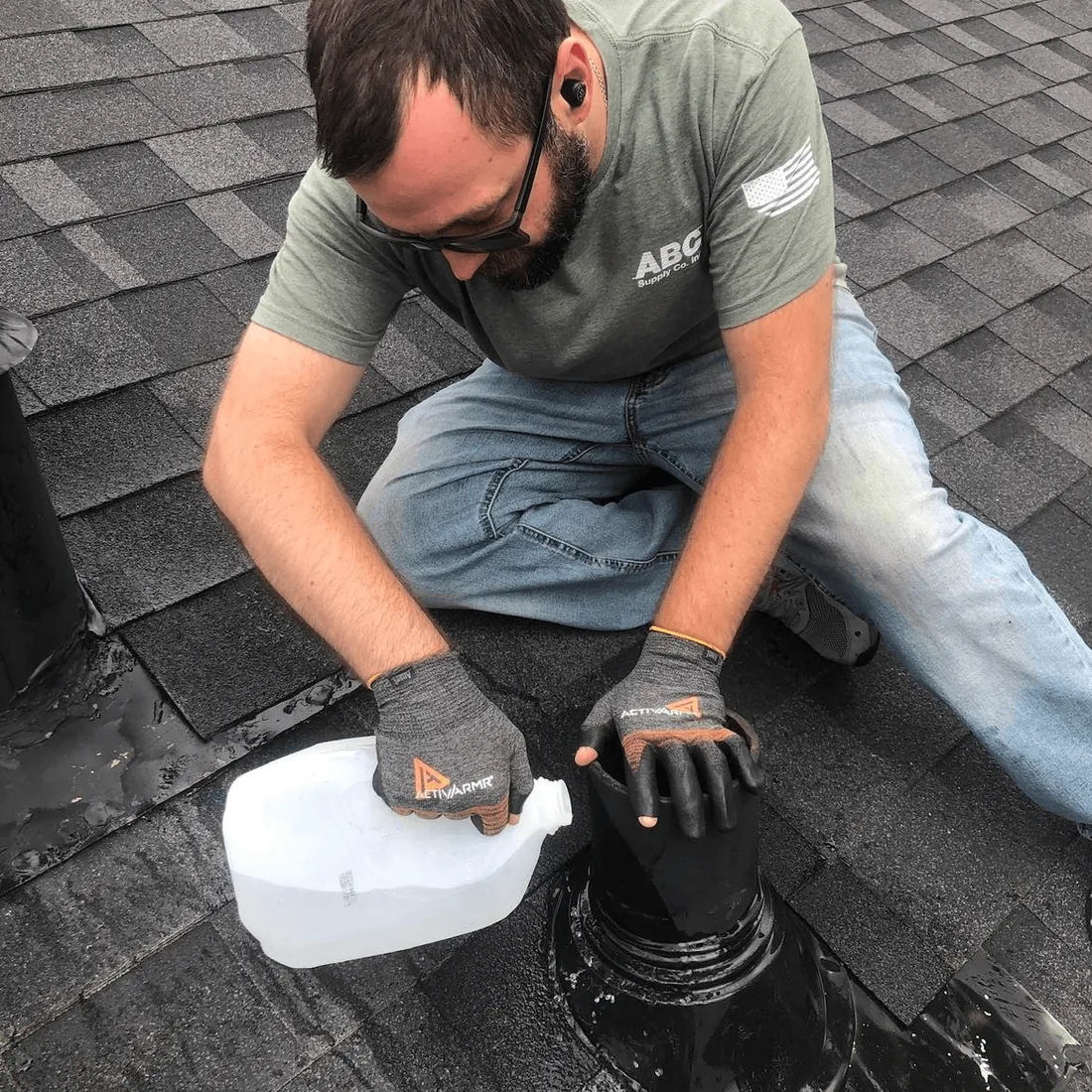 A New Summit Roofing crew member sealing a roof detail