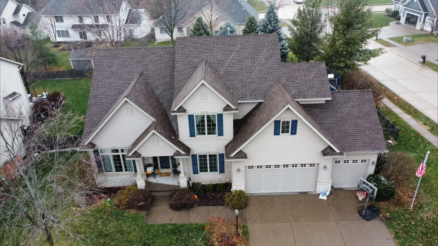 A two-story home with a new roof installed by New Summit Roofing