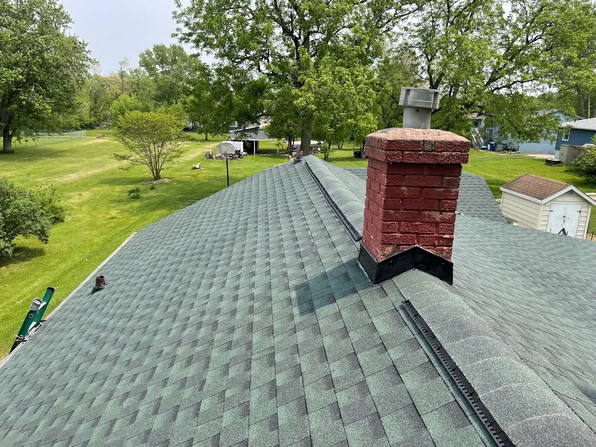 A home with a new weathered-wood shingle roof and brick chimney