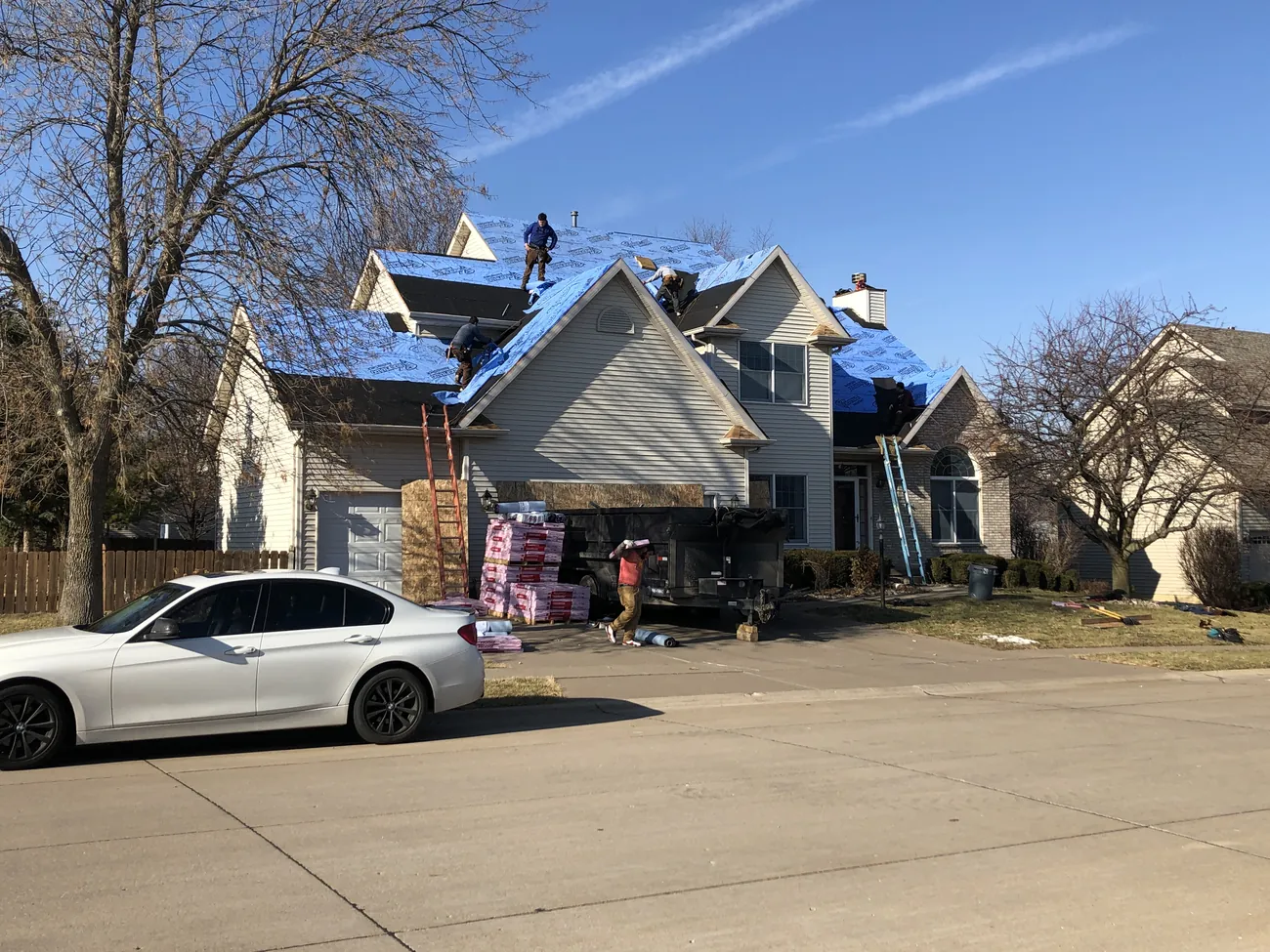 A New Summit Roofing crew tarping and protecting a storm-damaged roof