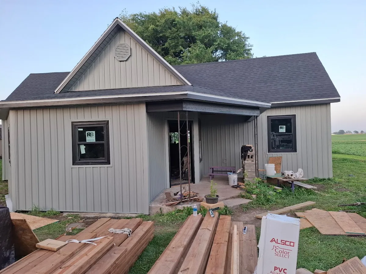 A modern gray board-and-batten home with new siding