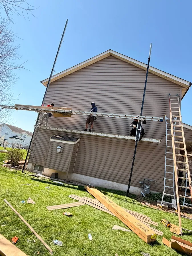 A siding installation in progress with scaffolding